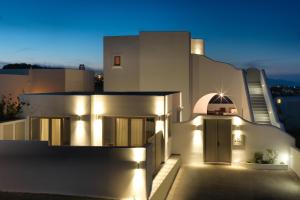 a white house with lights on the side of it at Drops Villas in Vóthon