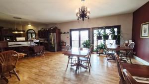 a dining room and kitchen with a table and chairs at Auberge Wild Rose Inn in Moncton