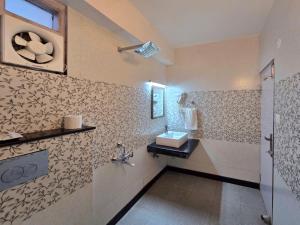 a bathroom with a sink and a toilet in it at Kavin Uphar The Mall Road in Shimla