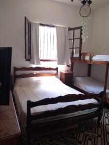 a bedroom with a large bed and a window at Los cristales unquillo in Unquillo