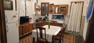 a kitchen with a table and a refrigerator at Los cristales unquillo in Unquillo