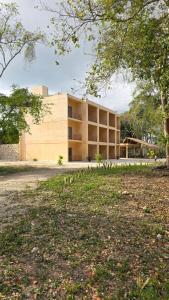a large building in the middle of a park at Hotel El Paraíso Calakmul - Jungle Experience in Xpujil
