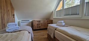a bedroom with two beds with towels on them at TomHouse in Skorochow