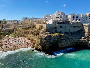 a group of people on a beach near the water at Cavalluccio Marino-Central-with Balcony by Gessica Holiday in Polignano a Mare