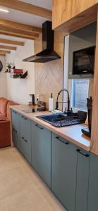 a kitchen with blue cabinets and a counter top at TomHouse in Skorochow