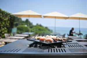 a grill with some food on top of it at "Cap Riviera" Hotel & Restaurant Saint Aygulf in Saint-Aygulf