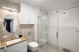 a bathroom with a shower and a toilet and a sink at Apartamenty Lipowa in Puck +31 photos