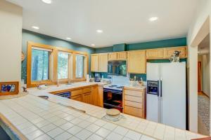 a kitchen with wooden cabinets and a white refrigerator at Idyllic Incline Village Getaway in Incline Village +22 photos