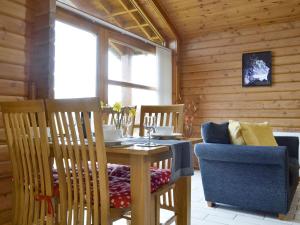 a dining room with a table and a chair at Seascape in Staffin