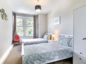 a bedroom with two beds and a window at 2 Bed in Bideford oc-3gabl in Appledore
