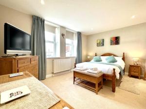 a bedroom with a bed and a flat screen tv at 2 Bed in Bideford oc-73895 in Westward Ho