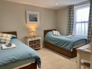 a small bedroom with two beds and a window at 2 Bed in Bideford oc-73895 in Westward Ho
