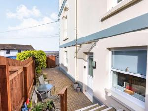a balcony of a house with a table and chairs at 2 Bed in Bideford oc-73895 in Westward Ho