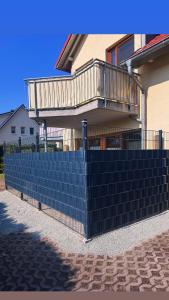 a blue retaining wall in front of a house at Ostseeperle Zingst, strandnahes 3-Zimmer Apartment in Zingst +5 photos