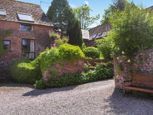 a bench sitting in front of a brick house at Horner- Ukc4923 in Timberscombe +15 photos