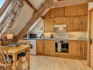 a kitchen with wooden cabinets and a wooden table at Horner- Ukc4923 in Timberscombe