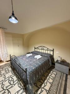 a bedroom with a bed with two towels on it at Angel House in Locorotondo