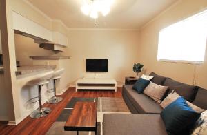 a living room with a couch and a tv at Stylish Austin Condo in Austin