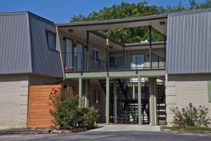 a large house with a balcony and a staircase at Stylish Austin Condo in Austin