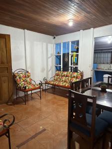 a living room with chairs and a table and a couch at GuestHouse Detours CR in Fortuna