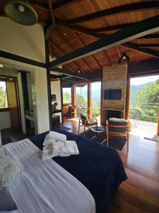 a bedroom with a bed with a blue comforter at Alto de Santa Barbara in São Francisco Xavier