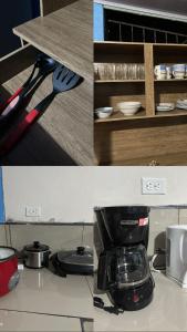 a kitchen counter with a coffee maker on a counter top at GuestHouse Detours CR in Fortuna +2 photos