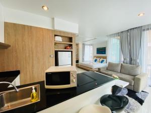 a living room with a tv and a couch at Buasri By Ohm in Patong Beach