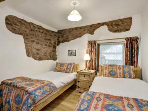a bedroom with two beds and a window at Luccombe- Ukc4919 in Timberscombe