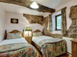 a bedroom with two beds and a window at Luccombe- Ukc4919 in Timberscombe