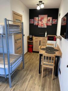 a room with a table and a bunk bed at Somni Apartamente in Chinteni +12 photos