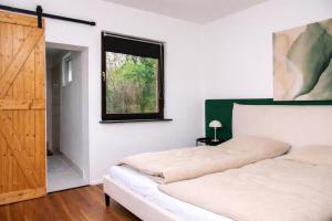 a bedroom with a bed and a window at Ferienhaus Wacholder in Mechernich
