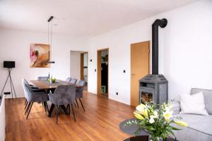 a living room with a table and a fireplace at Ferienhaus Wacholder in Mechernich