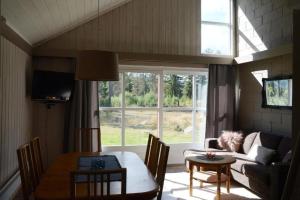 a living room with a table and a couch at 16 - Fulufjellets national parks - This is the place where Norway and Sweden meet in a large protected area in Ljørdal