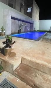 a swimming pool with a blue pool at Tecnoshow in Rio Verde