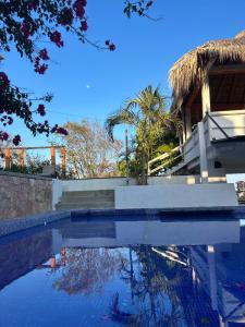 a swimming pool in front of a house at Casa PuntaBlanca in Puerto Ángel