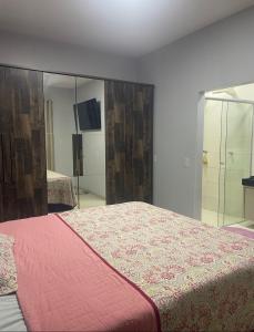 a bedroom with a bed and a large mirror at Tecnoshow in Rio Verde