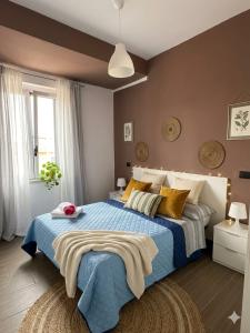 a bedroom with a large bed with blue sheets and yellow pillows at Crisvan Home in Capo Rizzuto