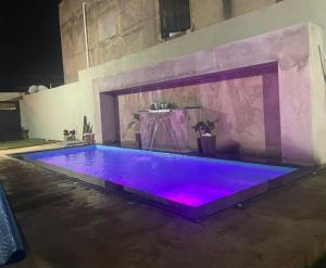 a large swimming pool with purple lighting in a room at Tecnoshow in Rio Verde