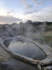 a small pool of water in a field with at La casa di Nonna Carta in Fordongianus