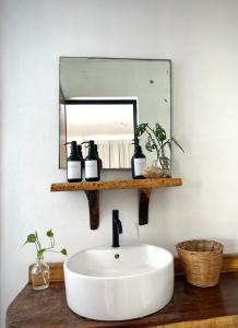 a bathroom with a white sink and a mirror at Casa PuntaBlanca in Puerto Ángel +19 photos