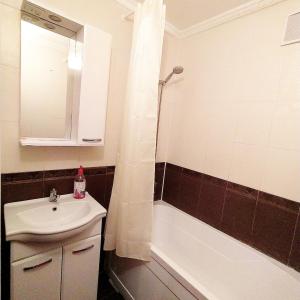 a bathroom with a sink and a bath tub at Аэропорт-Астана двухкомнатная in Astana +6 photos