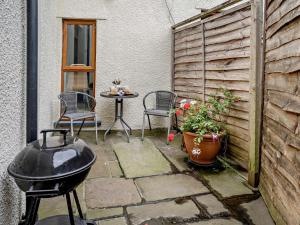 a patio with a table and chairs and a grill at 1 Bed in Brecon oc-bn367 in Bwlch +22 photos