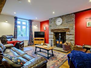 a living room with a couch and a fireplace at 3 Bed in Brecon oc-93680 in Llandefalle