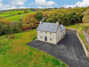 an aerial view of a stone house in a field at 3 Bed in Brecon oc-93680 in Llandefalle