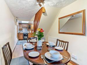 a dining room with a wooden table and chairs at 2 Bed in Brecon oc-bn138 in Bwlch