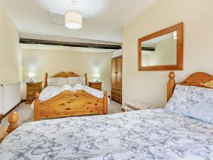 a bedroom with a bed and a mirror at 2 Bed in Brecon oc-bn138 in Bwlch