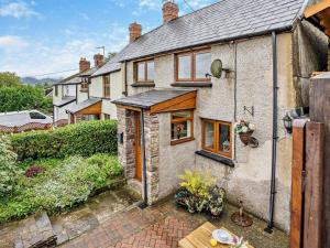 an old brick house with windows and a patio at 2 Bed in Brecon oc-bn138 in Bwlch