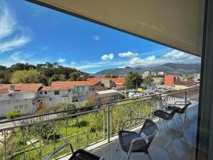 a balcony with chairs and a view of a city at Vega's in Tivat