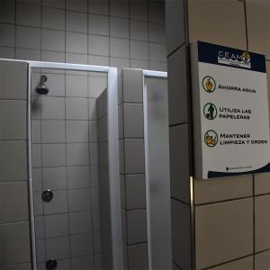 a stall in a bathroom with a sign on the wall at CEAM Tabarca in Tabarca +14 photos