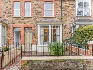 a brick house with a wrought iron fence at 4 Bed in Bideford oc-85720 in Bideford